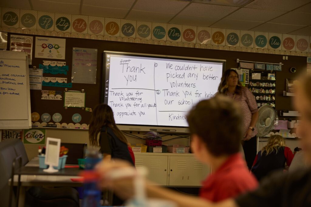 Students pay attention in to a presentation in the front of the classroom.