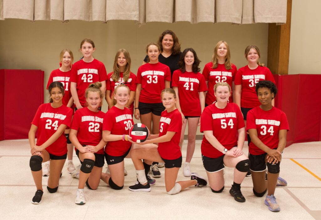 Girls Volleyball team at Abiding Savior Lutheran School all pose for a team photo.