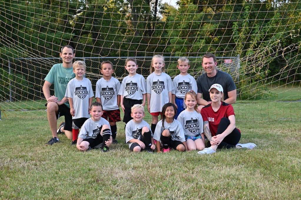 Pre-K Soccer Athletes at Abiding Savior Lutheran School pose for a team photo on the soccer field.